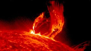 A huge loop of fiery plasma bursts out of the sun's surface