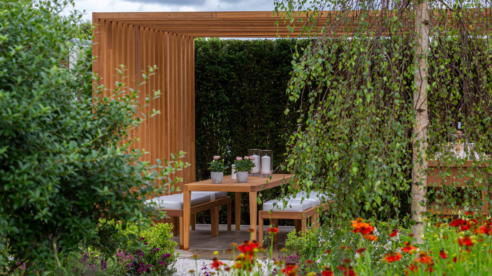 wooden pergola with dining area and planting