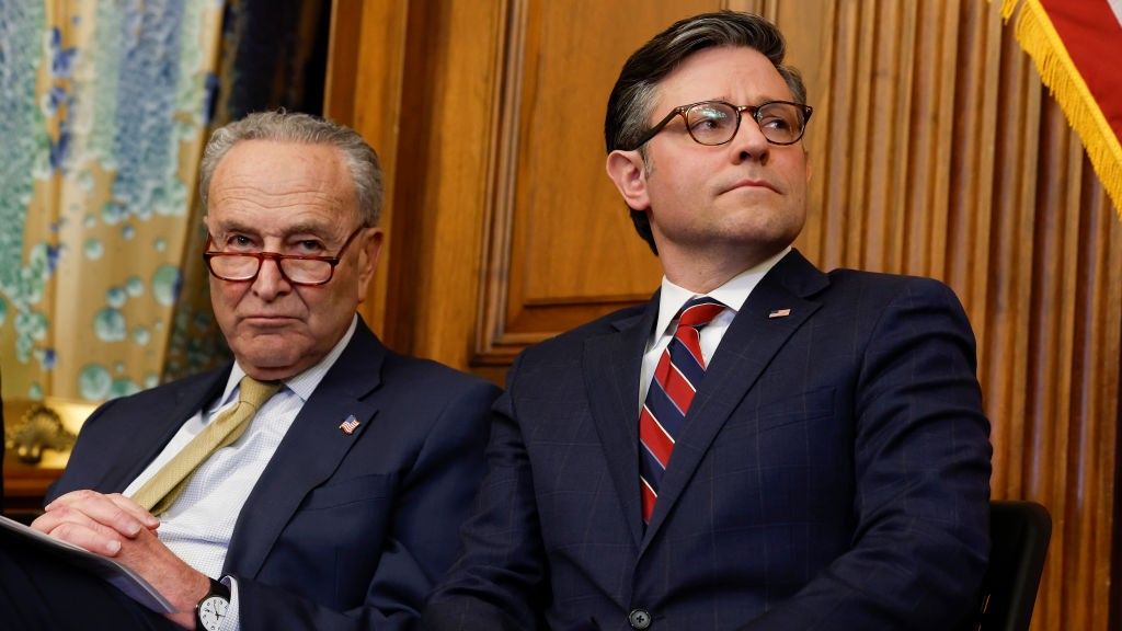 Chuck Schumer and Mike Johnson seated with each other