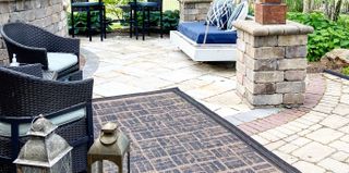 a painted outdoor rug on a patio