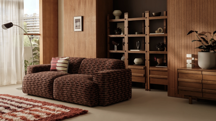 Barbican X MADE furniture collection showing a burgundy-maroon sofa with textured covers inside a scandi style flat
