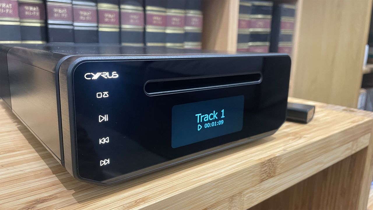 A side-on view of a black Cyrus 40 CD CD player. The buttons can be seen on the left of the front panel, with the screen in the middle underneath the CD slot.