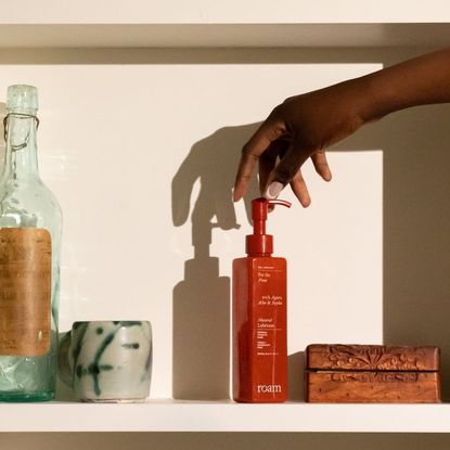 What lube is: A hand grabbing a bottle of lube