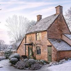 A traditional cottage and its frosty-covered front garden