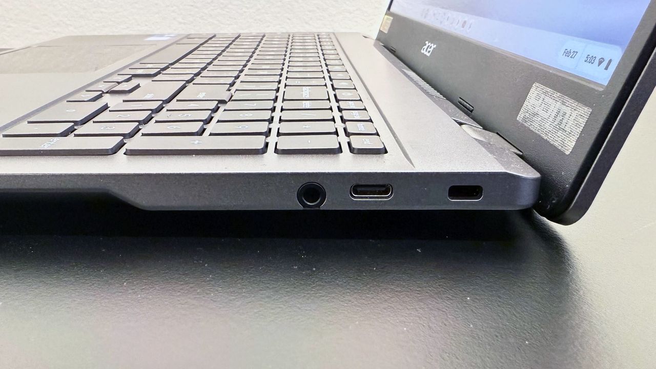 Close up of the right-side ports on the Acer Chromebook Plus Enterprise 515, on a black desk against a white background.