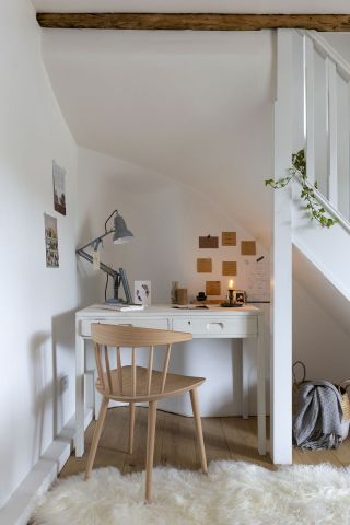 Desk fit perfectly into small space with white paint and lamp