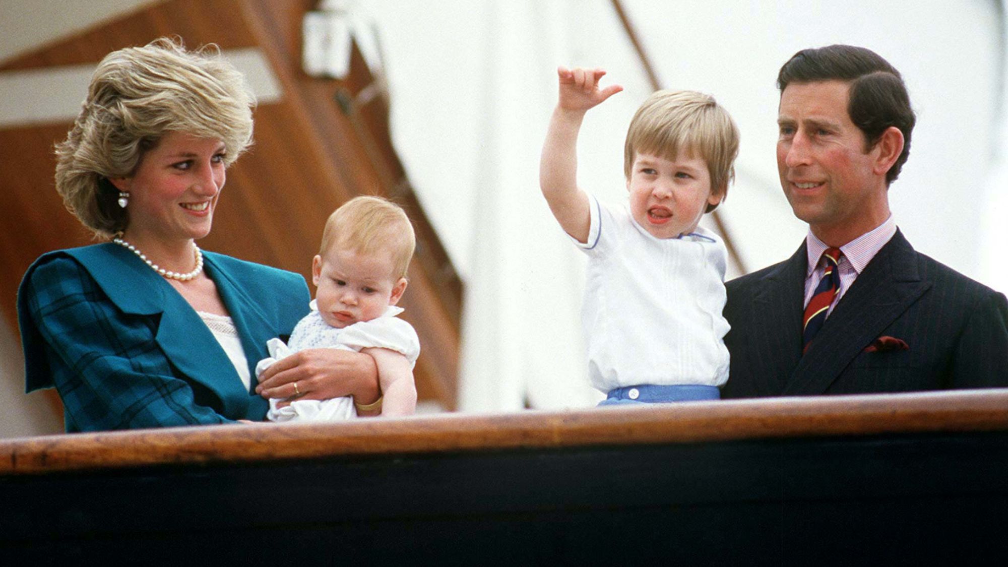 Princess Diana and King Charles holding Prince William and Prince Harry aboard the Royal Yacht Britannia