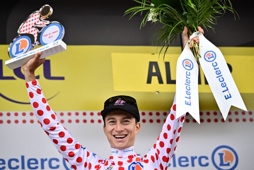 EF Education - Easypost's US rider Neilson Powless celebrates on the podium with the best climber's dotted jersey after the 11th stage of the 110th edition of the Tour de France cycling race, 180 km between Clermont-Ferrand and Moulins, in central France, on July 12, 2023. (Photo by Marco BERTORELLO / AFP)