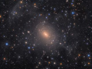 This is a deep imager of the peculiar, elliptical galaxy NGC 3923. The galaxy features myriad concentric shells as a result of past mergers with other nearby galaxies. Photographer Rolf Wahl Olsen captured this with a homebuilt 12.5" Serrurier Truss Newtonian telescope at f/4, Losmandy G-11 mount, QSI 683wsg-8 camera, L-RGB composite, 41 hours 38 minutes total exposure.