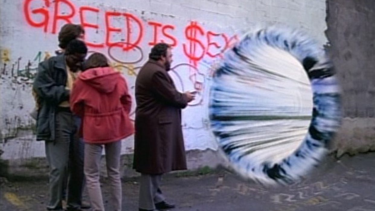 Screenshot from the sci-fi TV shows Sliders, featuring three people standing in front of a wormhole.