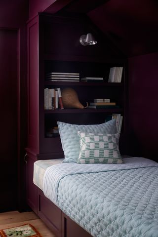 A burgundy alcove bedroom