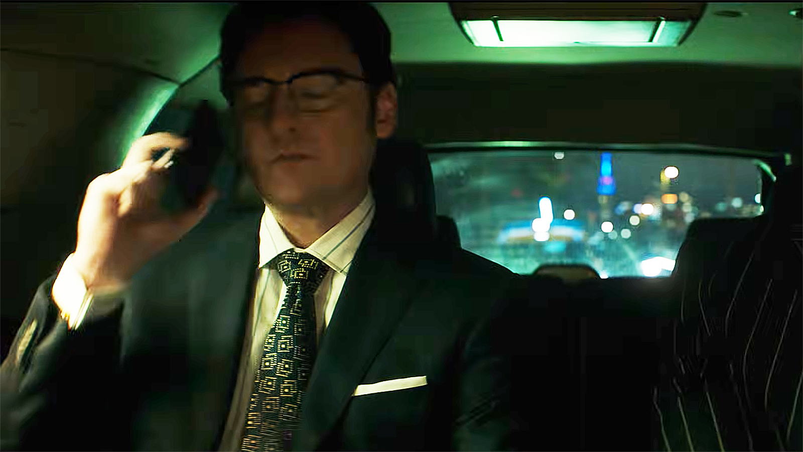 James Wesley sitting in a car and holding a mobile phone to his right ear in Daredevil: Born Again season 2 episode 5