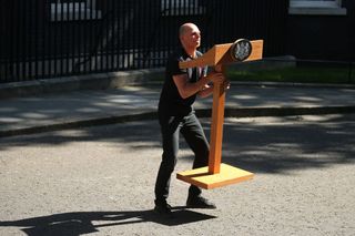 Downing street lectern carried by a member of staff for David Cameron