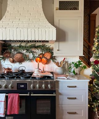 christmas decor in a shaker kitchen and a brick cooker hood