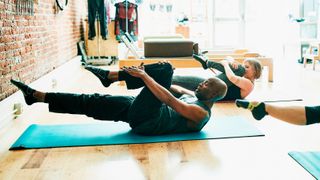 Man and woman in Pilates class