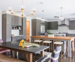 Gray kitchen with double island and dining table