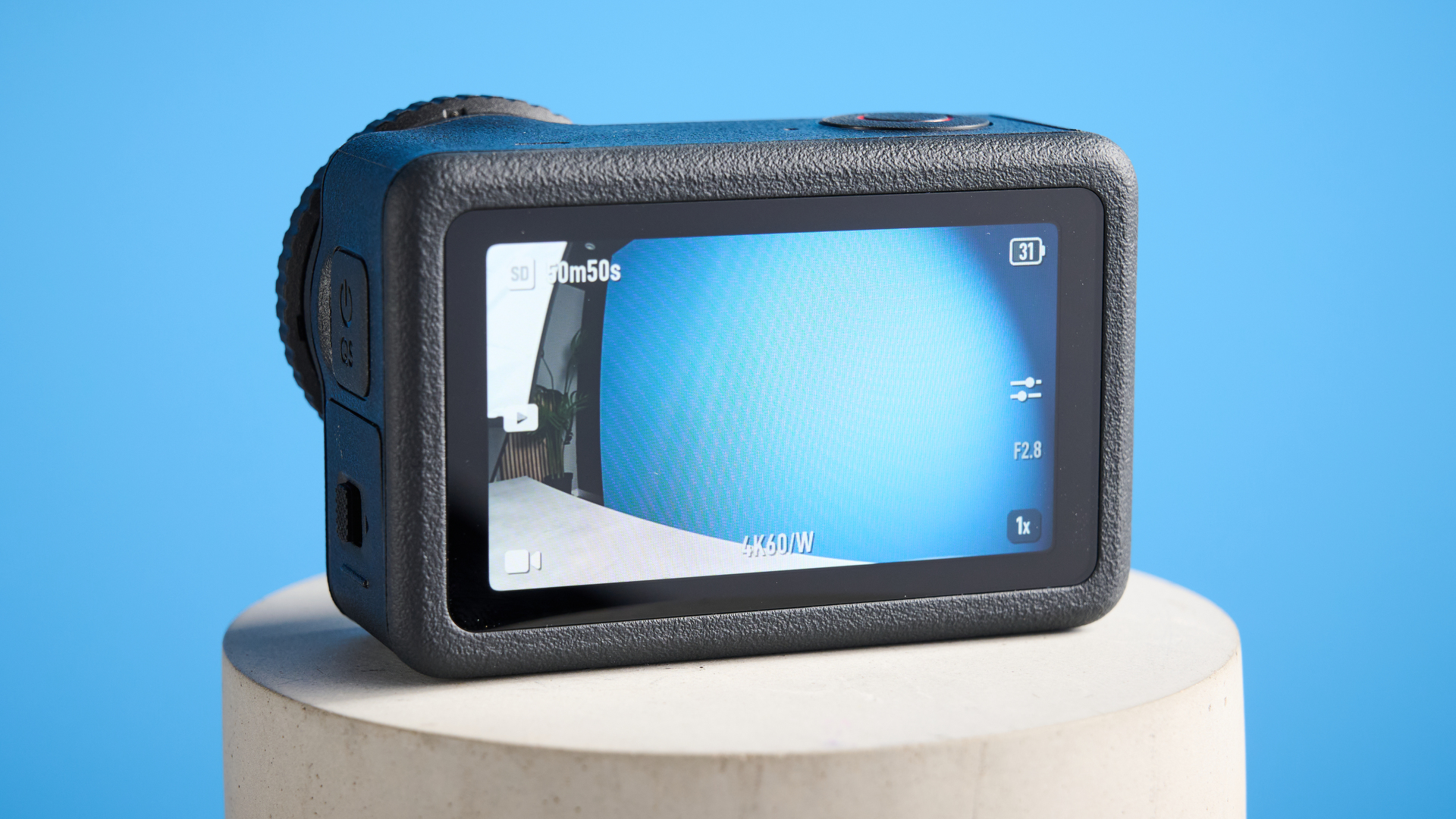 The DJI Osmo Action 6 on a stone surface with a blue background