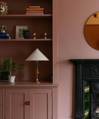 dark pink painted walls and built in units in alcove