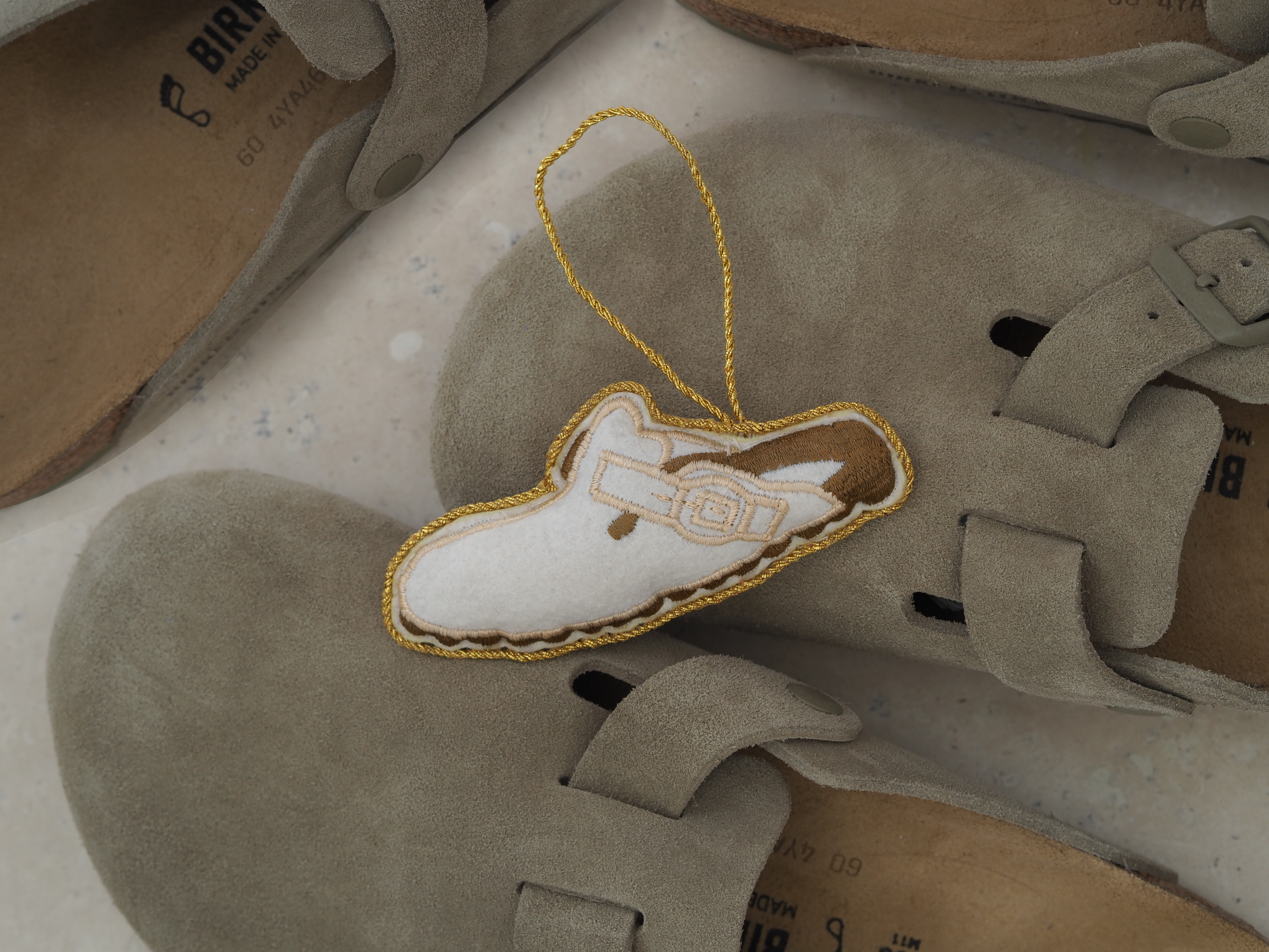 a bauble of a birkenstock boston sandal on top of actual sandals