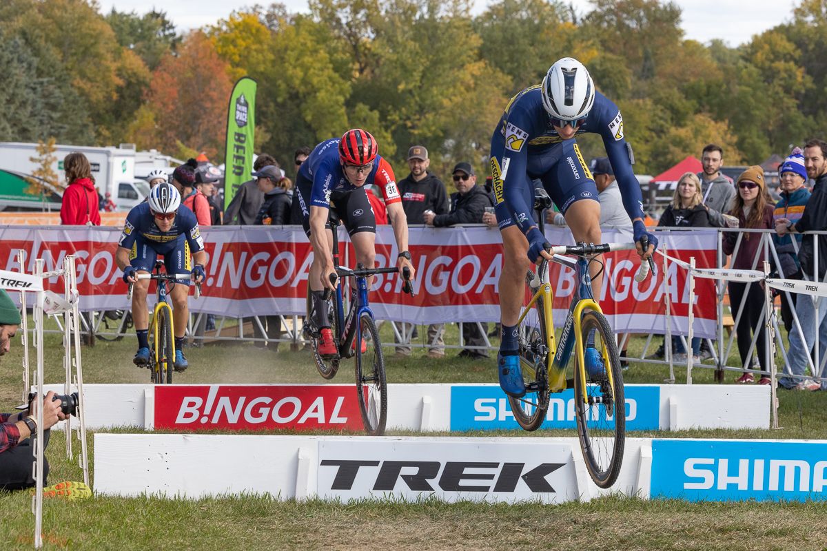 Lander Loockx (Deschacht - Hens - Maes), Thijs Aerts (Baloise Trek Lions), and Daan Soete (Deschacht - Hens - Maes) lead the men's field over the barriers early in the race.