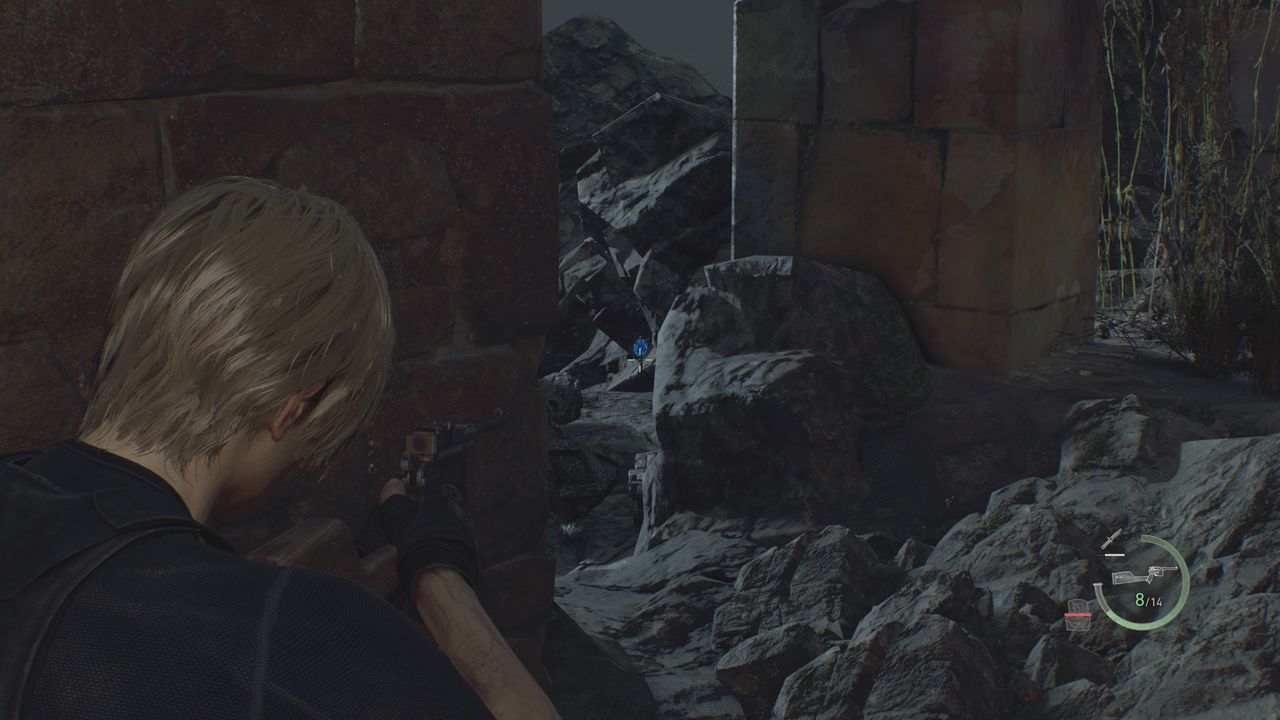 Resident Evil 4 Remake Blue Medallion inbetween some rocks