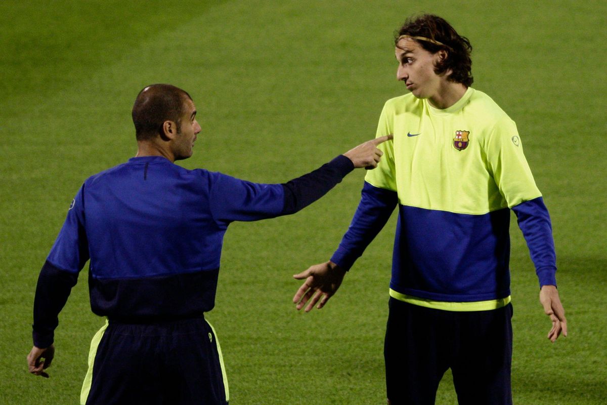 Barcelona manager Pep Guardiola instructs Zlatan Ibrahimovic during a training session at the Club World Cup in Abu Dhabi, UAE, December 2009