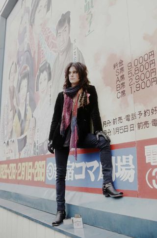 Gilby Clarke Guns N' Roses in front of theater signboard in Shinjuku, Tokyo, January 1992