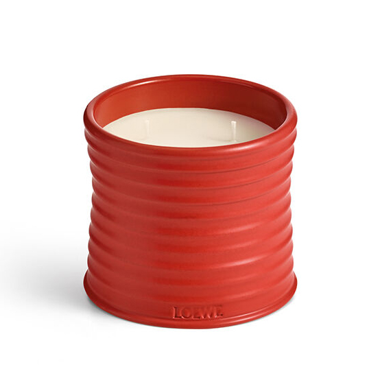 red ceramic candle on white background