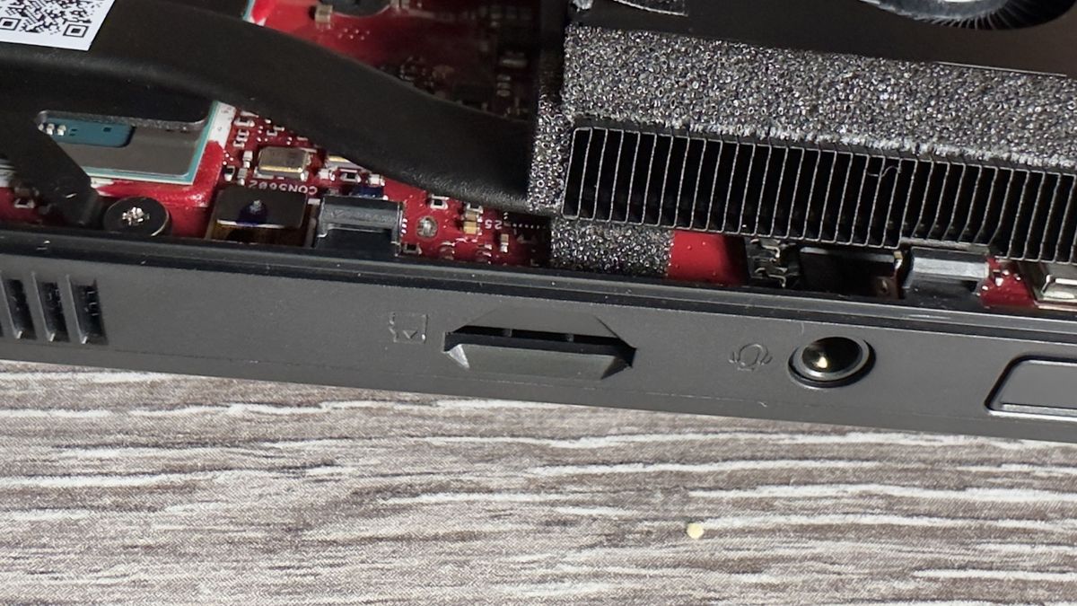 A photo of the interior of an Asus ROG Ally X handheld gaming PC, showing the device's components and layout