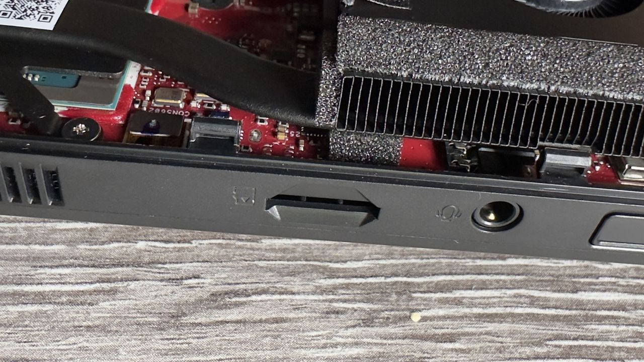 A photo of the interior of an Asus ROG Ally X handheld gaming PC, showing the device's components and layout