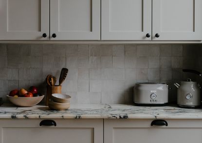 A kitchen with two types of handles