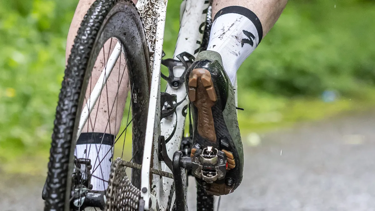 The S-Works Recon Lace Shoe being ridden showing details of the sole attached to a Shimano pedal