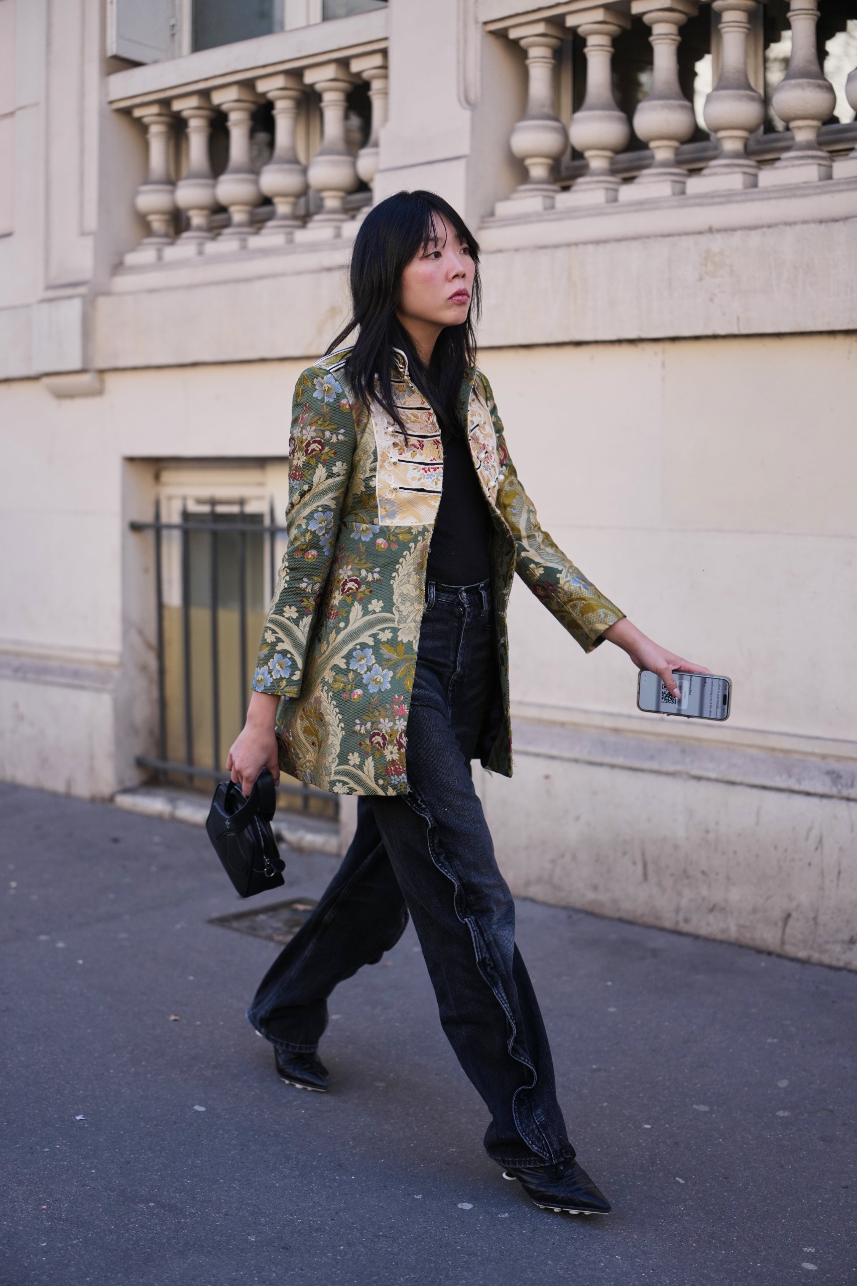 woman wearing brocade jacket and black pants