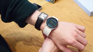 Samsung Galaxy Watch 7 on a wrist next to an old-fashioned watch