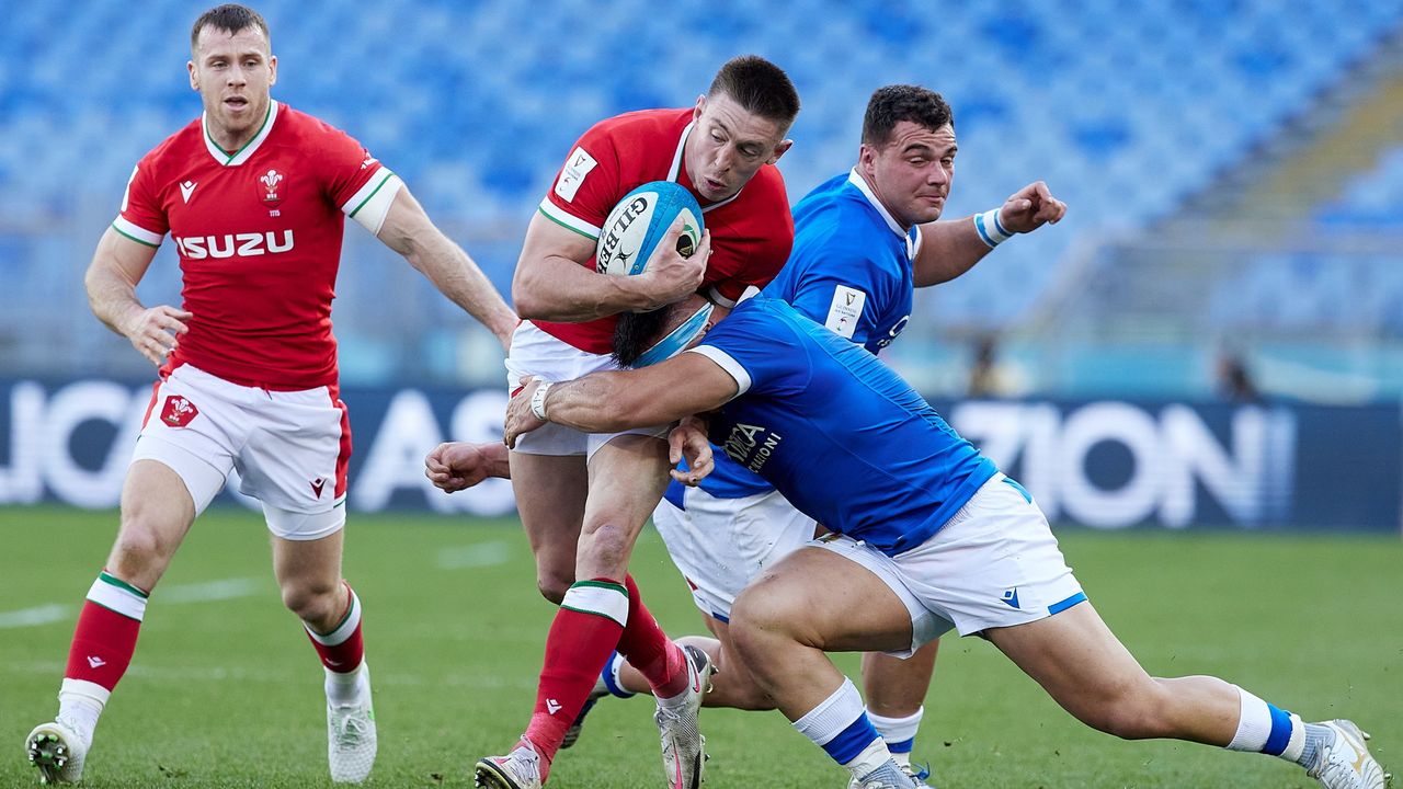 Josh Adams of Wale is tackled by David Sisi of Italy during the Guinness Six Nations match between Italy and Wales