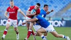 Josh Adams of Wale is tackled by David Sisi of Italy during the Guinness Six Nations match between Italy and Wales