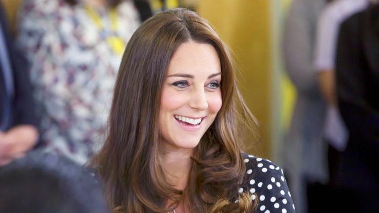 Smiling Kate Middleton wearing polka dot dress