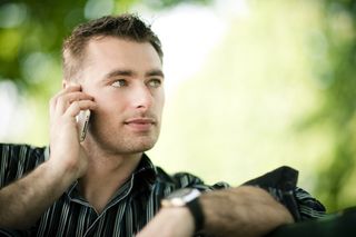 A man on a cell phone in nature