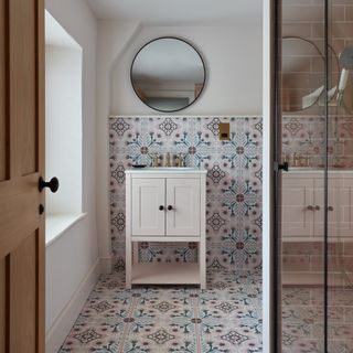Ensuite bathrom with patterned wall and floor tiles