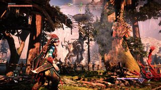 Aloy looks at a Tallneck through trees in an abandoned settlement