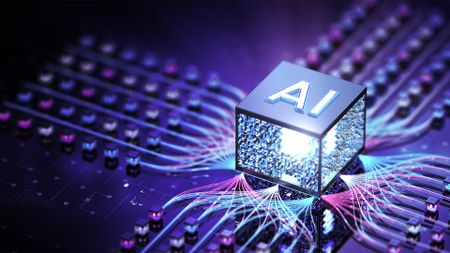 Artificial intelligence (AI) concept image showing a digitized cube with 'AI' written on it resting on top of circuit boards.