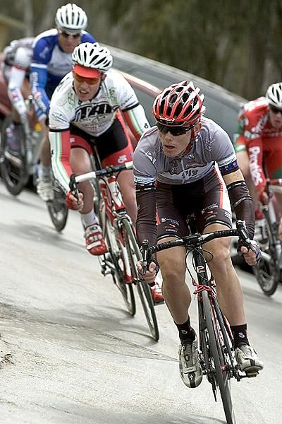 Hayden Brooks (Fly V Australia) corners during the criterium with two of his teammates in the break up ahead.