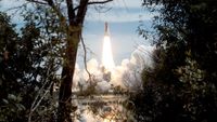 Trees and shrubs frame the liftoff of space shuttle Endeavour as the STS-69 mission begins on Sept. 7, 1995.