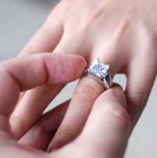 man putting a ring on a womans finger