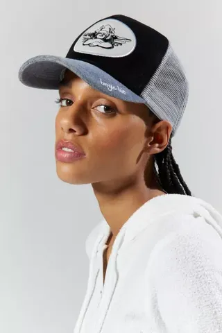 a model wears a velvet trucker hat