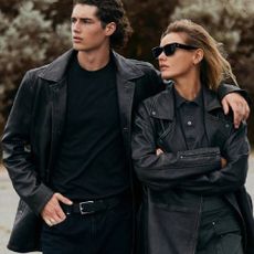 A male and female model wearing leather jackets and a black outfit from Wilsons Leather.