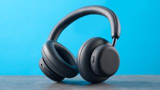 the cmf headphone pro / cmf by nothing headphone pro / nothing headphone pro in black photographed against a blue tom's guide background