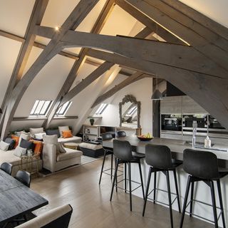 attic kitchen area with sofa set and wooden floor