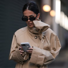 close up of a woman on her phone wearing a beige coat - Fresh start nails 