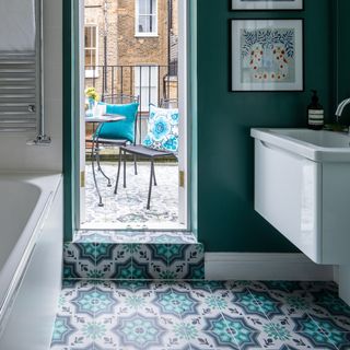 green and white bathroom stepping outside